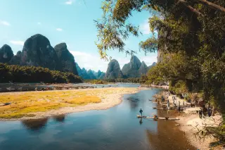 Guilin karst towers rising from mist over the river valley